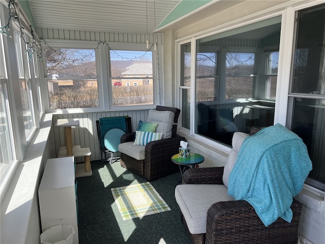 sunroom / solarium featuring vaulted ceiling