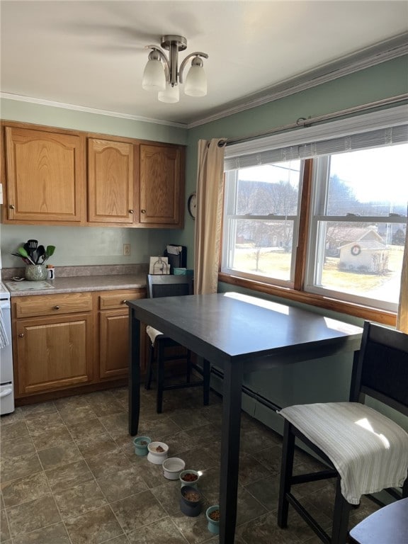 kitchen featuring a chandelier, brown cabinets, light countertops, and ornamental molding