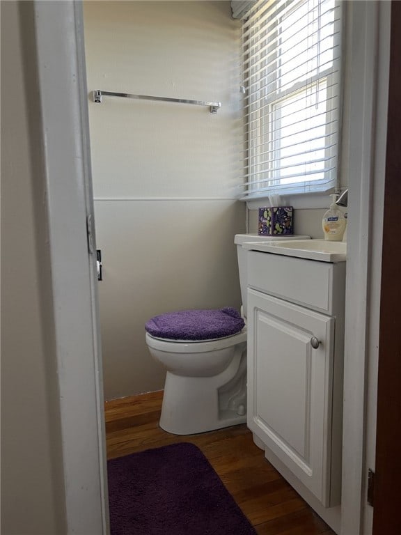 bathroom with vanity, toilet, and wood finished floors