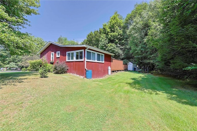 view of property exterior featuring an outdoor structure, a storage shed, and a yard