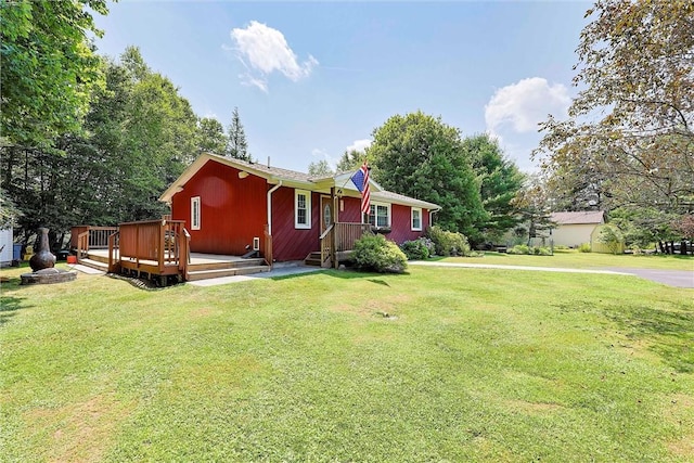 view of front of home with a wooden deck and a front lawn