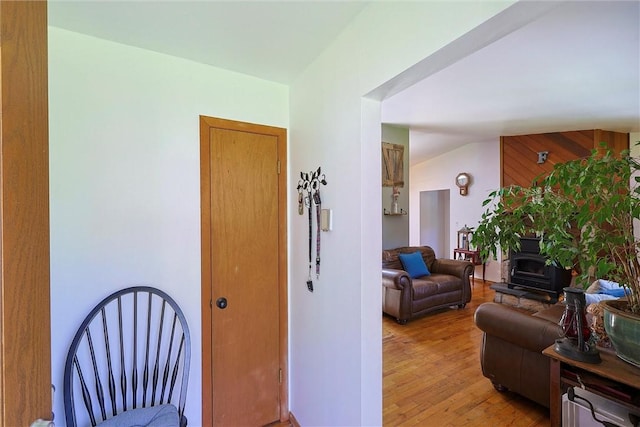 interior space featuring light wood-type flooring and vaulted ceiling