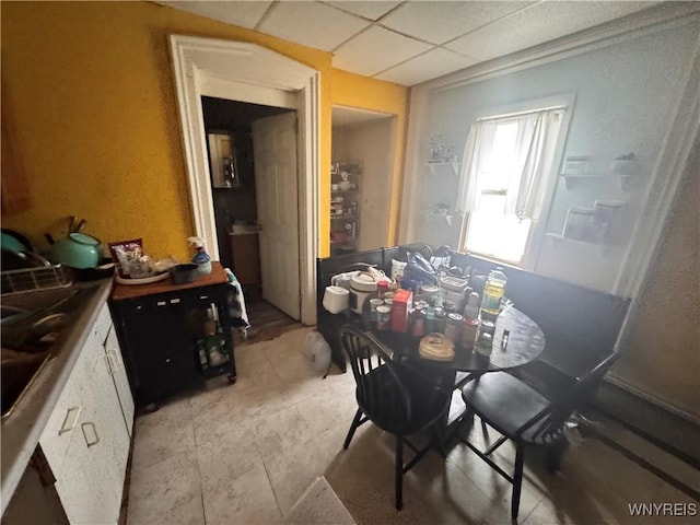 dining area featuring a drop ceiling