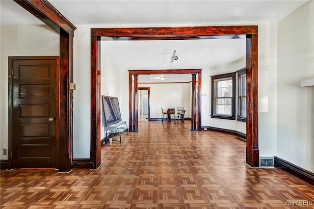 corridor featuring visible vents and baseboards