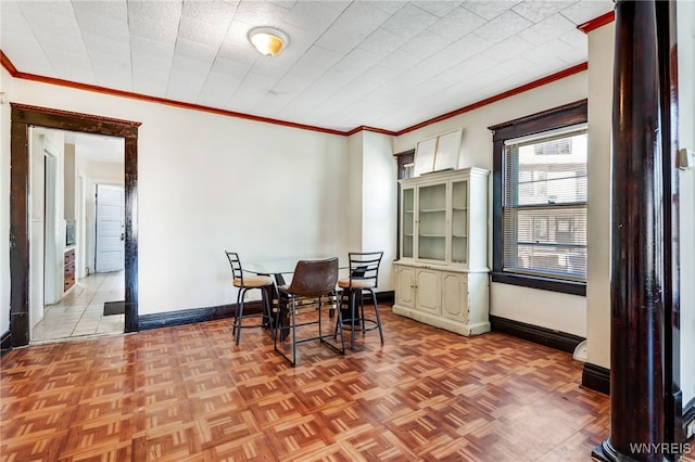 dining space with baseboards and ornamental molding