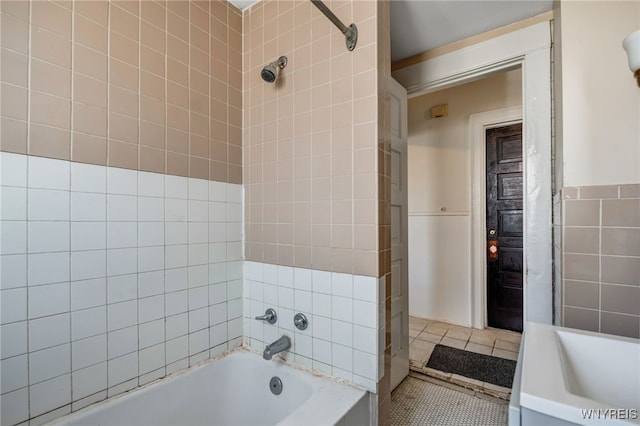 full bath with tile patterned floors and tile walls