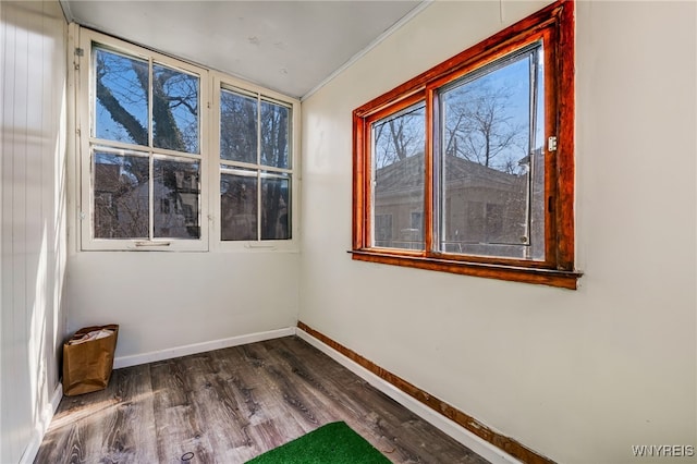 unfurnished room featuring dark wood-style floors and baseboards