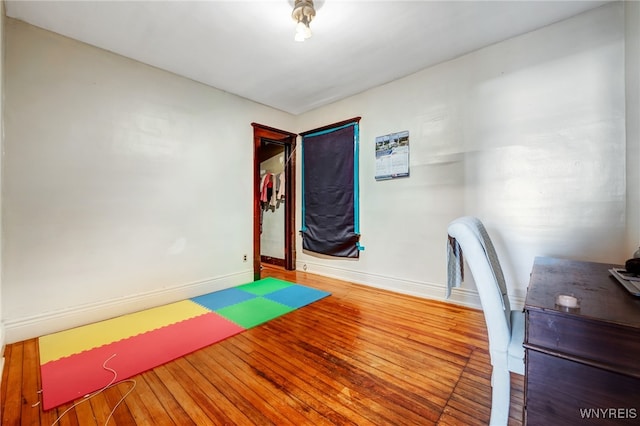 office with baseboards and wood finished floors