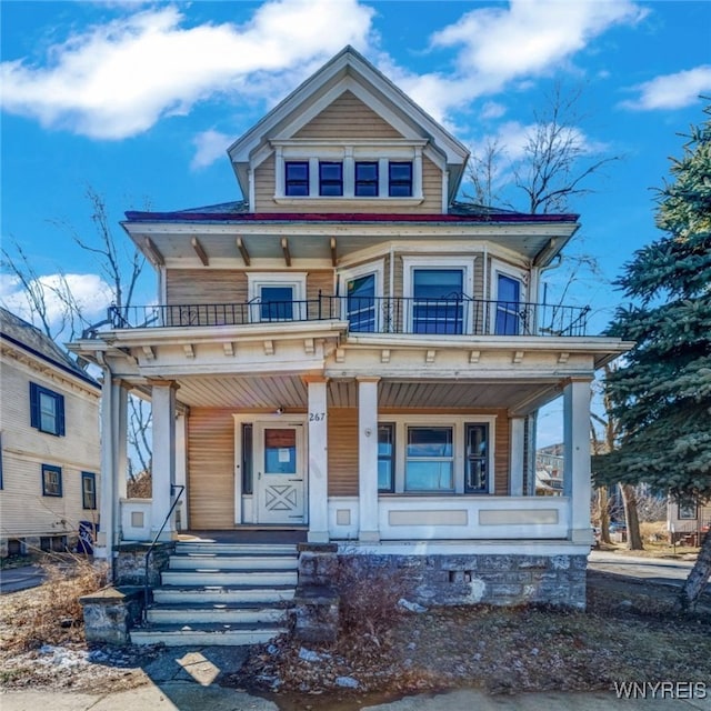 view of front facade with a balcony and covered porch