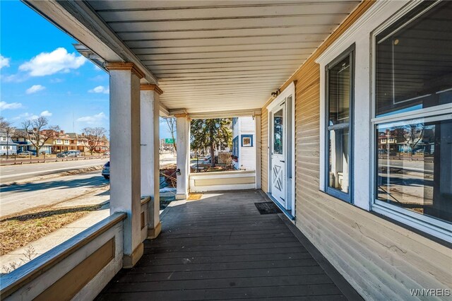 deck with a residential view and a porch