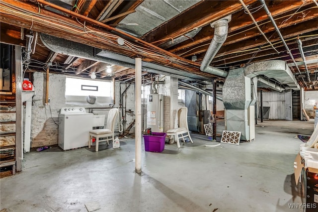 basement with gas water heater, washer and clothes dryer, and a sink