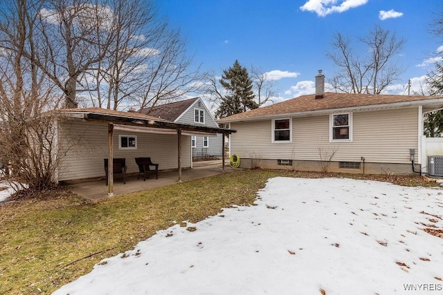 back of house featuring a patio area, central AC unit, and a chimney