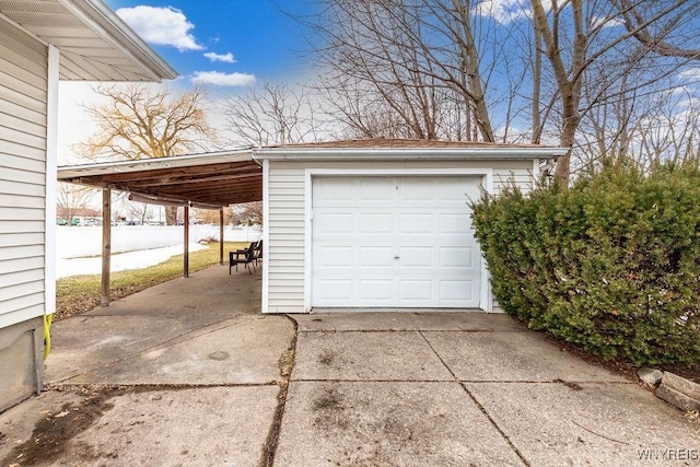 garage with a detached garage and concrete driveway