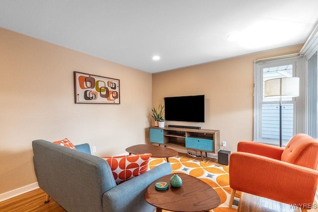 living room with recessed lighting, baseboards, and wood finished floors