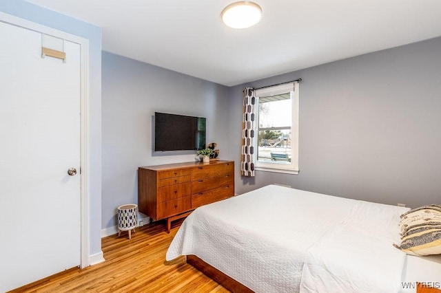 bedroom with baseboards and light wood-style floors