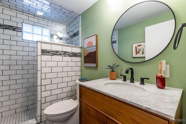 bathroom featuring a walk in shower, toilet, and vanity