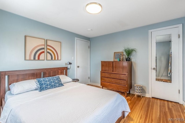 bedroom featuring baseboards and wood finished floors