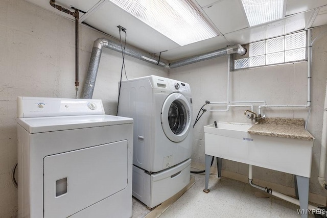 washroom with separate washer and dryer and laundry area