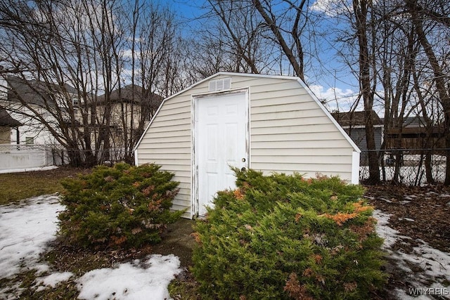 view of shed featuring fence