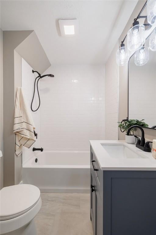 bathroom featuring toilet, vanity, and shower / tub combination