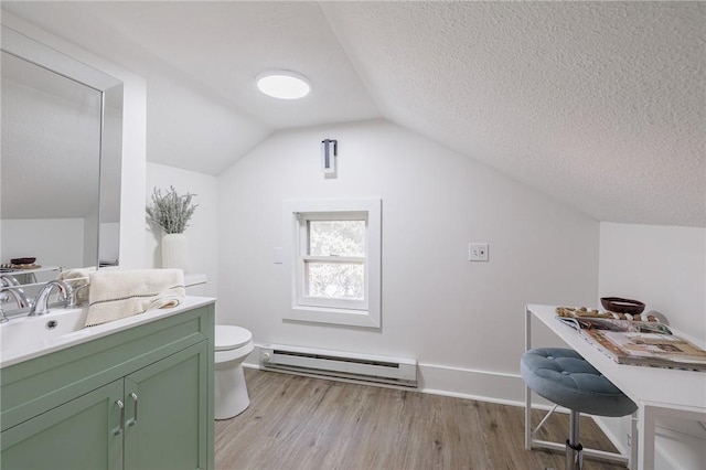 bathroom featuring vanity, wood finished floors, vaulted ceiling, toilet, and baseboard heating