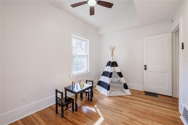 rec room with visible vents, baseboards, light wood finished floors, and ceiling fan