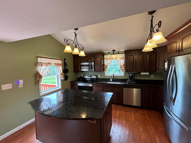 kitchen featuring dark wood-style flooring, a sink, vaulted ceiling, dark brown cabinets, and appliances with stainless steel finishes