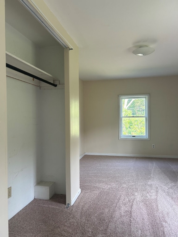 unfurnished bedroom with baseboards and carpet floors