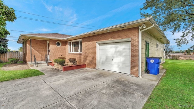 single story home featuring brick siding, driveway, a front lawn, and a garage