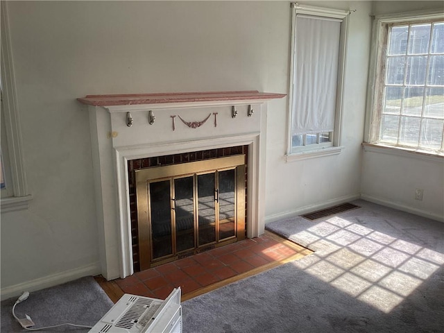 interior details featuring carpet flooring, a fireplace, visible vents, and baseboards