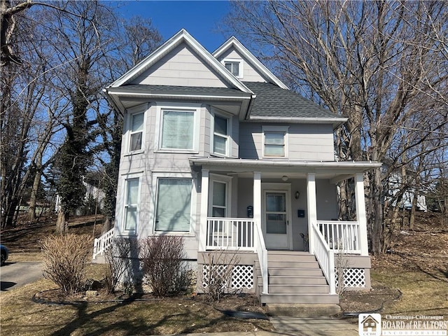 view of front of house featuring covered porch and a shingled roof