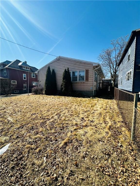 view of side of home with fence