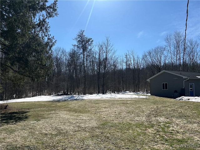 view of yard with a view of trees