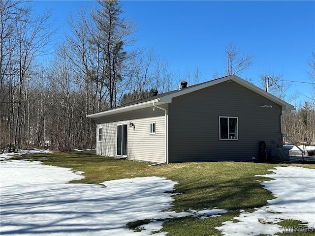 snow covered property featuring a lawn