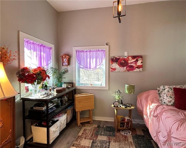 bedroom featuring wood finished floors and baseboards