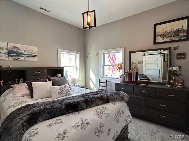 bedroom with visible vents and light carpet