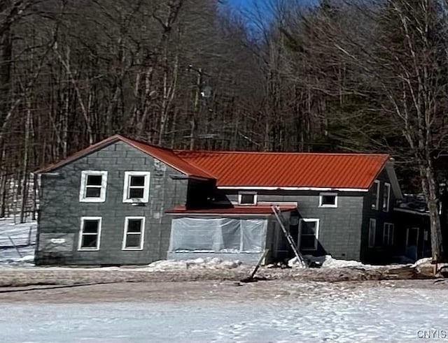 view of front facade with metal roof and concrete block siding