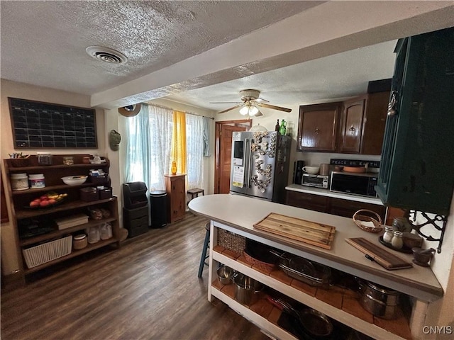 kitchen with dark brown cabinetry, dark wood-type flooring, black microwave, a textured ceiling, and refrigerator with ice dispenser