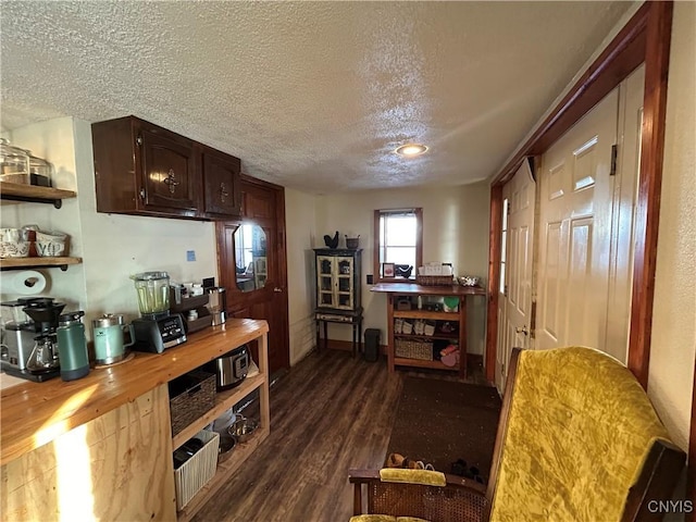 interior space featuring open shelves, a textured ceiling, dark brown cabinetry, wooden counters, and dark wood-style flooring