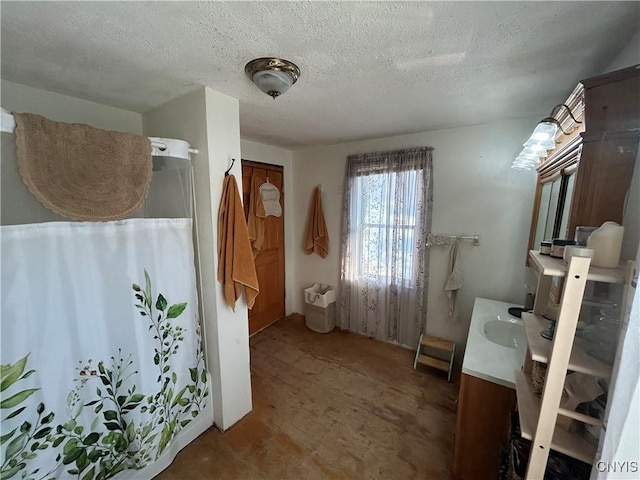 bathroom with vanity, a shower with curtain, and a textured ceiling