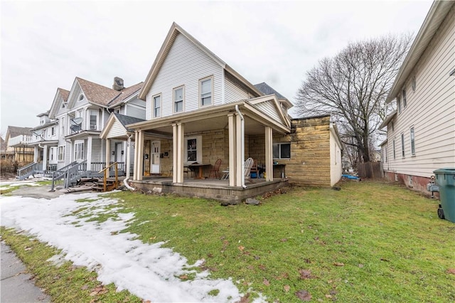 view of front facade featuring a front yard and stone siding