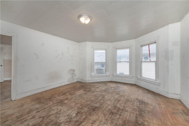 unfurnished room with wood finished floors