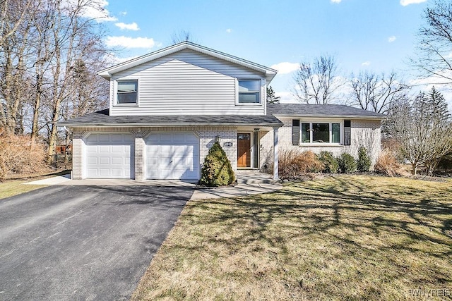 tri-level home with brick siding, a garage, driveway, and a front lawn