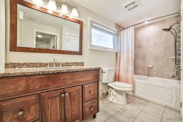 bathroom featuring vanity, visible vents, shower / tub combo, tile patterned floors, and toilet