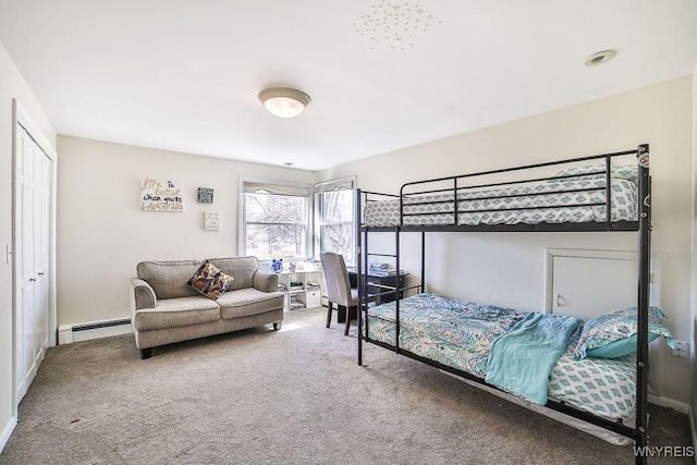 carpeted bedroom with a baseboard radiator, baseboards, and a closet