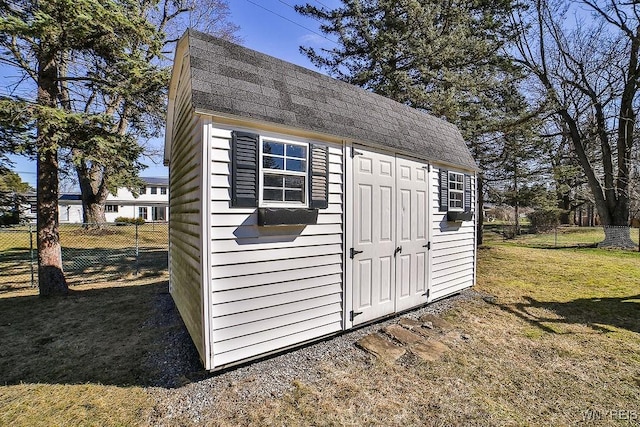 view of shed featuring fence