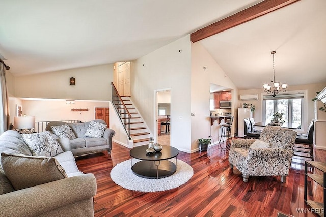 living area featuring beam ceiling, a chandelier, stairs, and wood finished floors