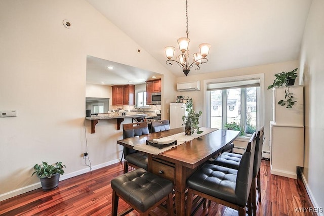 dining room with a wall mounted air conditioner, baseboards, a chandelier, dark wood-style flooring, and vaulted ceiling