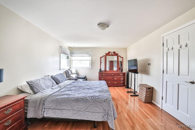 bedroom featuring baseboards and light wood-style flooring