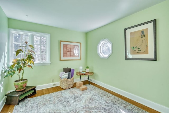 sitting room featuring baseboards and wood finished floors